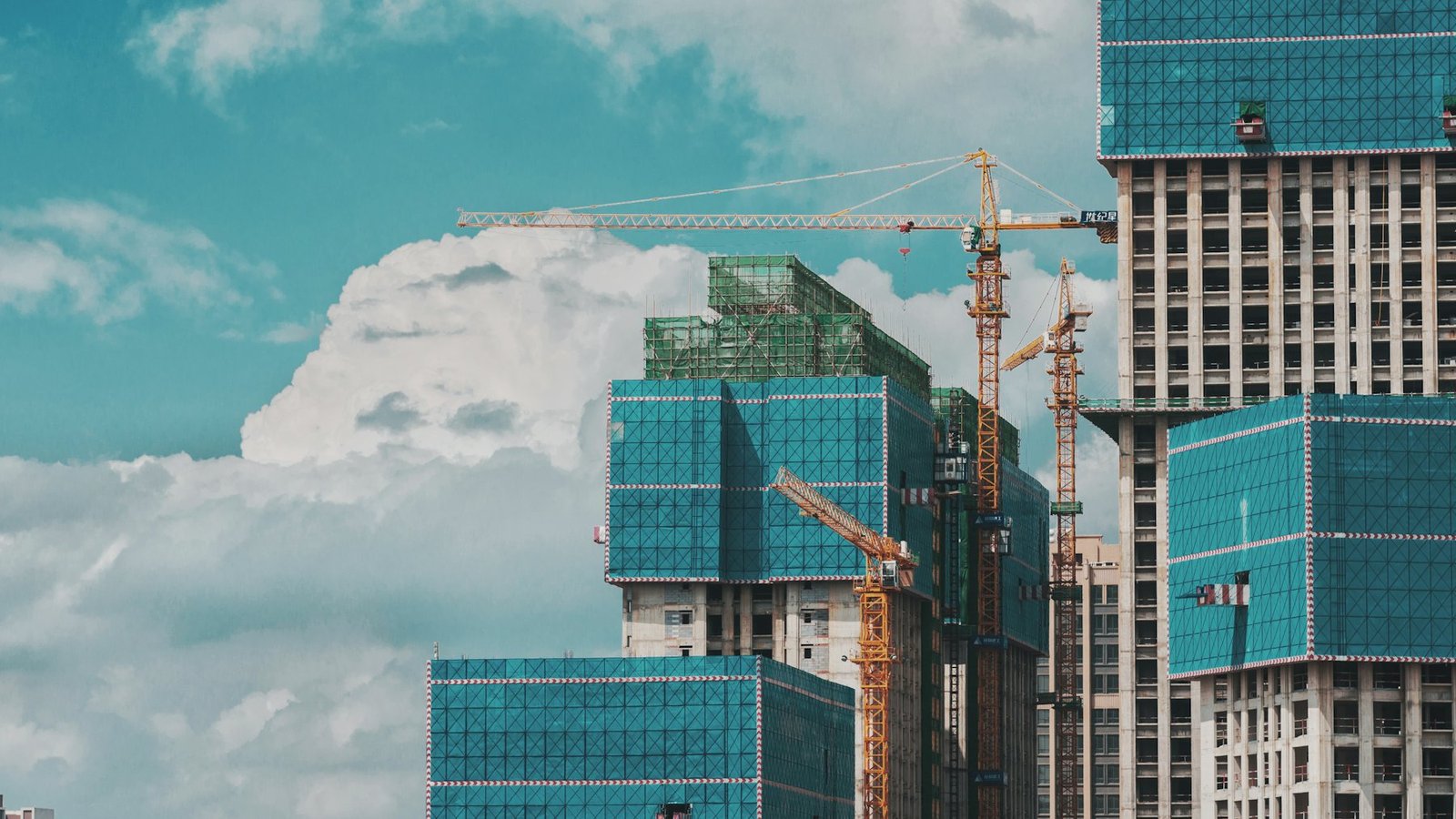 High-rise buildings under construction with tower cranes